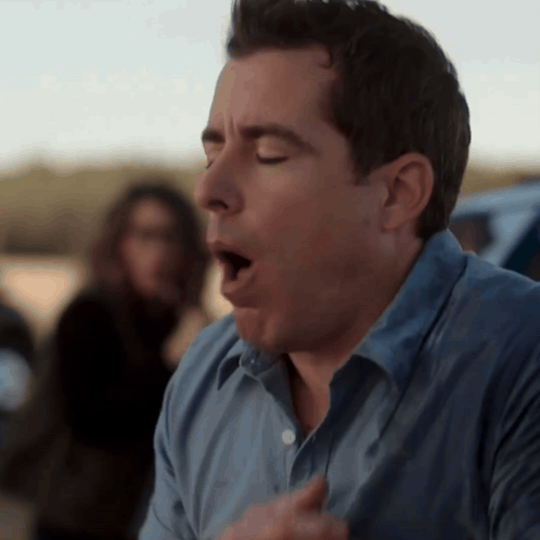 A Man In A Blue Shirt With His Mouth Open GIF
