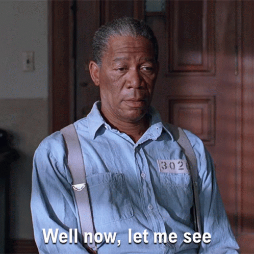A Man In A Blue Shirt With Suspenders And A Number 302 On His Shirt Says Well Now Let Me See GIF