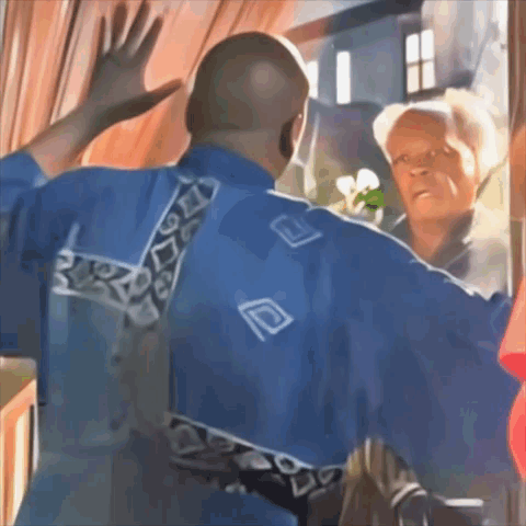 A Man In A Blue Shirt With The Letter D On The Back Is Waving GIF