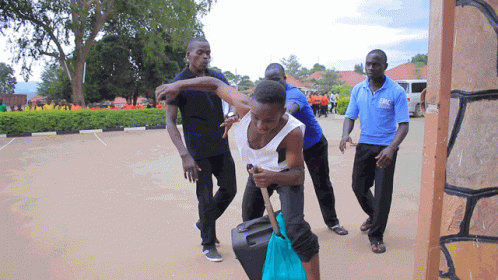 Man In Blue Shirt Holding Woman GIF