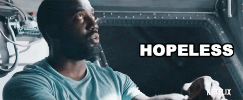 A Man In A Blue Shirt With The Word Hopeless Written Above Him GIF