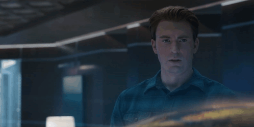 A Man In A Blue Shirt With The Words Let 'S Go Get This Son Of A Bitch Behind Him GIF