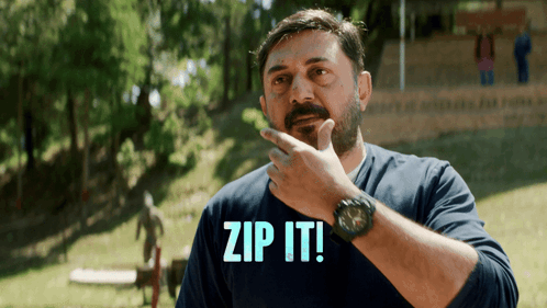A Man In A Blue Shirt With The Words Zip It On It GIF