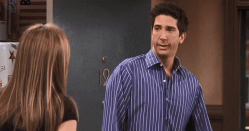 a man in a blue striped shirt is talking to a woman in a black shirt and says you know what