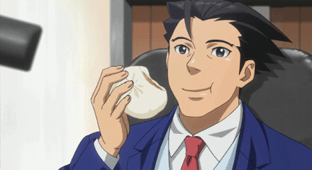 A Man In A Blue Suit And Red Tie Is Holding A Small White Object In His Hand GIF