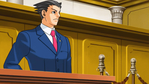 A Man In A Blue Suit And Red Tie Stands At A Podium In A Courtroom GIF