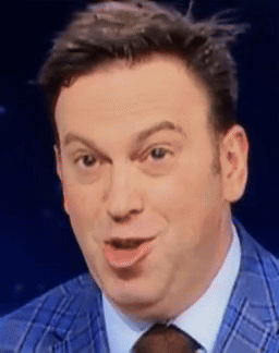 A Man In A Blue Suit And Tie Is Making A Face GIF
