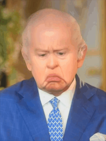 A Man In A Blue Suit And Tie Making A Sad Face GIF