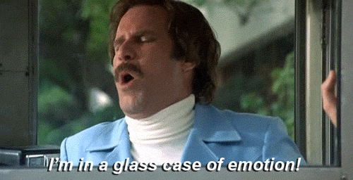 A Man In A Blue Suit And White Turtleneck Is Saying `` I 'M In A Glass Case Of Emotion! '' GIF