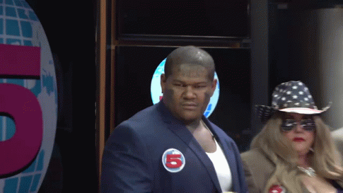 a man in a blue suit has a sticker on his jacket that says 5