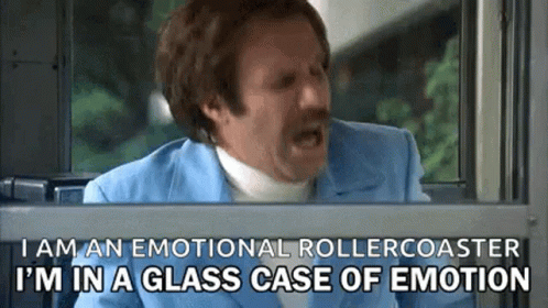A Man In A Blue Suit Is Looking Out Of A Window And Says I Am An Emotional Rollercoaster . GIF