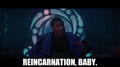 A Man In A Blue Suit Is Standing In Front Of A Stained Glass Window . GIF