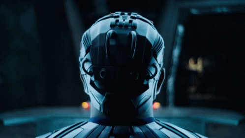 A Man In A Blue Suit Is Standing Next To A Woman In White GIF