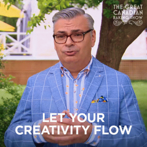 A Man In A Blue Suit Says Let Your Creativity Flow In Front Of A Tree GIF