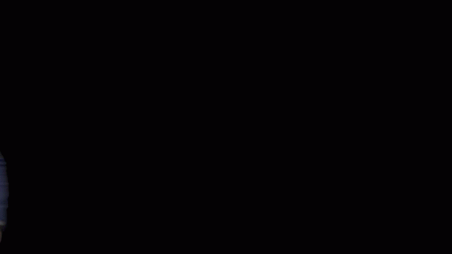 A Man In A Blue Suit Stands In Front Of A Mpire Estates Logo GIF