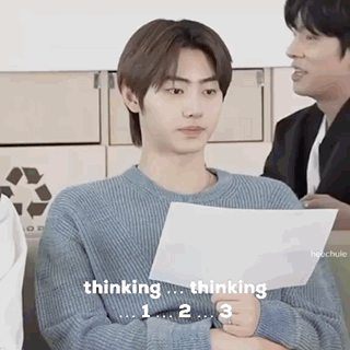 A Man In A Blue Sweater Is Holding A Piece Of Paper And Thinking . GIF