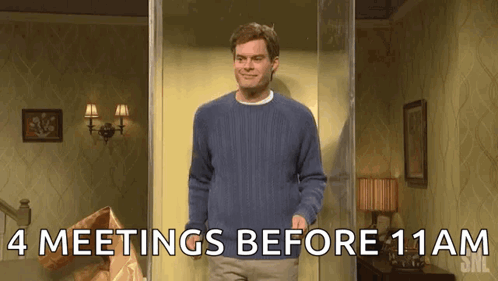 A Man In A Blue Sweater Is Standing In A Room With The Words " 4 Meetings Before 11Am " Written On The Bottom GIF