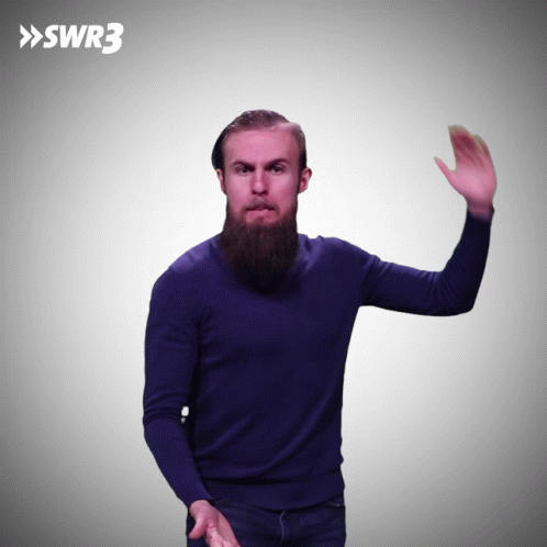 A Man In A Blue Sweater Is Waving His Hand In Front Of A Swr3 Logo GIF