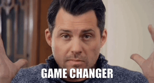 A Man In A Blue Sweater With The Words Game Changer On His Face GIF