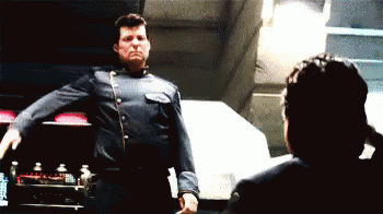 Man In Blue Uniform In Front Of Woman GIF