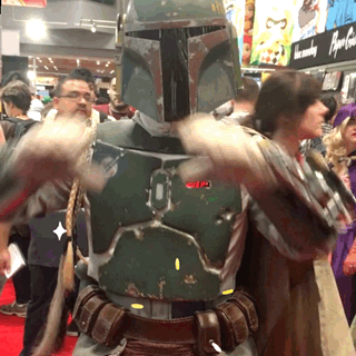 A Man In A Boba Fett Costume Stands In Front Of A Crowd GIF