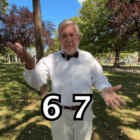 A Man In A Bow Tie Is Standing In A Park With The Number 6 And 7 On His Shirt GIF