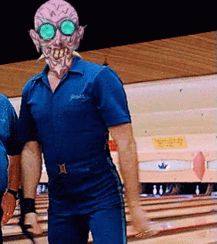 A Man In A Bowling Alley With A Mask On GIF