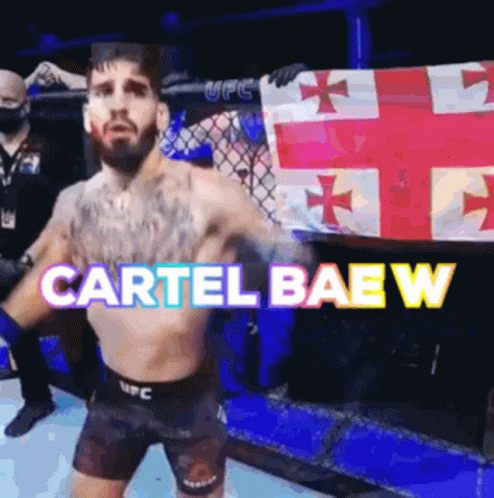 A Man In A Boxing Ring Is Holding A Flag And The Words Cartel Baew Are Above Him GIF