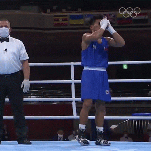 A Man In A Boxing Ring Wearing A Mask And Gloves GIF