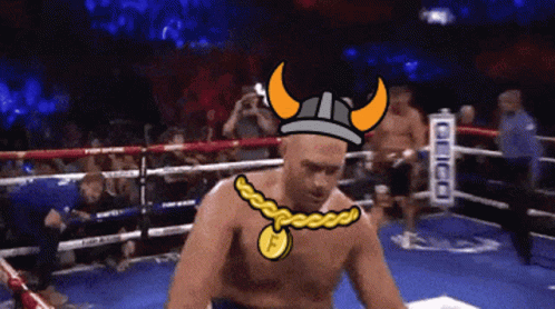 A Man In A Boxing Ring Wearing A Viking Helmet And A Necklace With The Letter F On It GIF