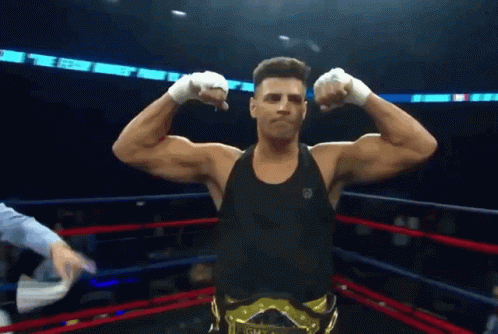 A Man In A Boxing Ring With A Belt That Says Gm GIF