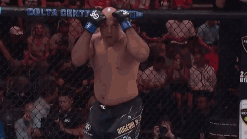A Man In A Boxing Ring With A Delta Center Banner In The Background GIF