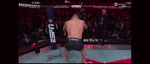 A Man In A Boxing Ring With A Espn Banner Behind Him GIF