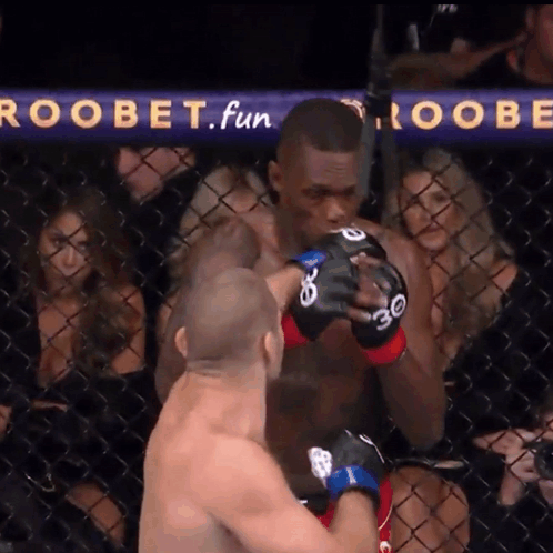 A Man In A Boxing Ring With A Sign That Says Roobet Fun GIF