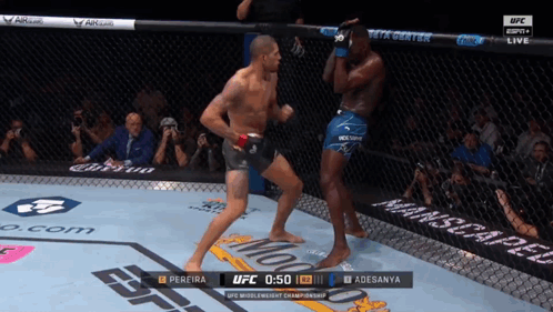 A Man In A Boxing Ring With The Ufc Logo On The Side GIF