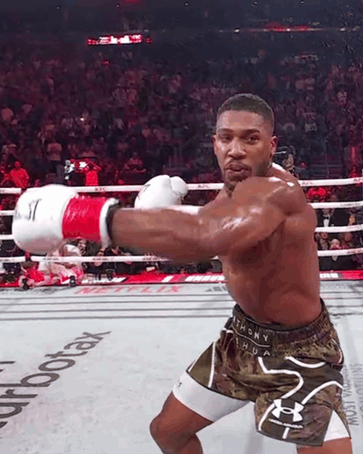 A Man In A Boxing Ring With The Word Aerotax On The Floor GIF