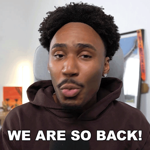 A Man In A Brown Hoodie With The Words We Are So Back Behind Him GIF
