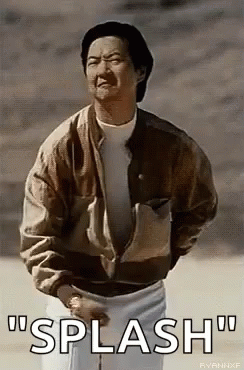 A Man In A Brown Jacket And White Shorts Is Standing In The Dirt And Talking . GIF