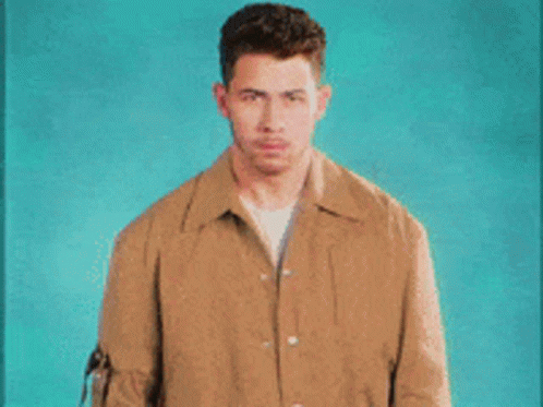 A Man In A Brown Jacket Covering His Mouth With His Hands And The Words Pretends To Be Shocked GIF