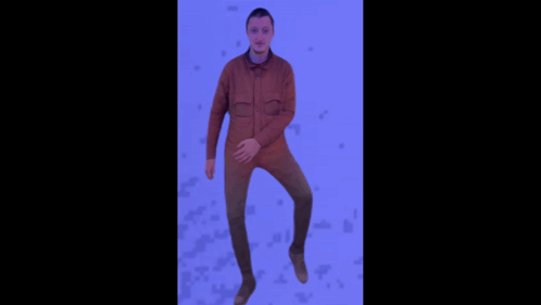 A Man In A Brown Jacket Is Jumping In The Air With His Arms Outstretched GIF
