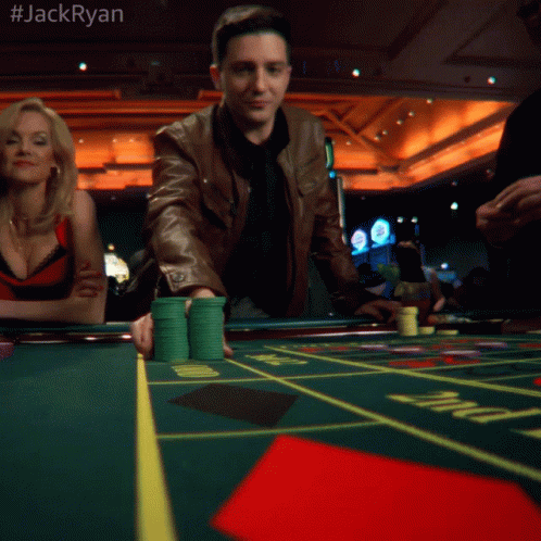A Man In A Brown Jacket Is Playing Roulette In A Casino With The Hashtag #Jackryan GIF