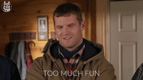 A Man In A Brown Jacket Is Smiling With The Words Too Much Fun Behind Him GIF