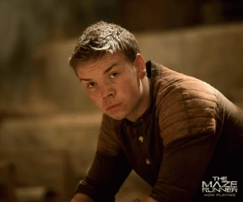A Man In A Brown Shirt With The Maze Runner New Beginning Written On The Bottom GIF