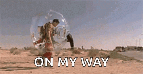 A Man In A Bubble Is Walking Down A Road With The Words `` On My Way '' Behind Him . GIF