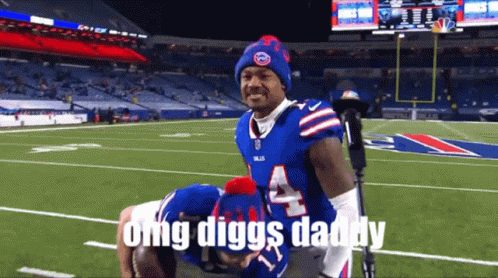 A Man In A Buffalo Bills Uniform Is Carrying Another Man On His Back GIF