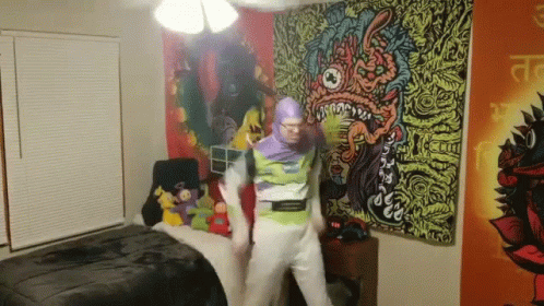A Man In A Buzz Lightyear Costume Is Dancing In A Room GIF
