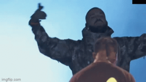 A Man In A Camo Jacket Is Giving A Middle Finger In Front Of A Blue Sky .. GIF