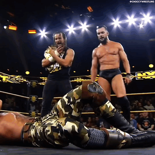 A Man In A Camo Outfit Is Laying On The Ground In A Ring GIF