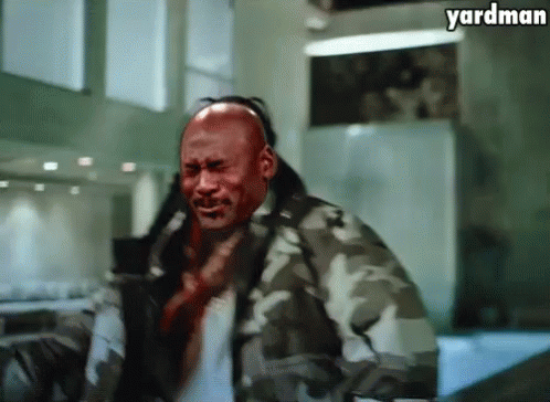 A Man In A Camouflage Jacket Has Blood On His Face And The Words Yardman Above Him GIF