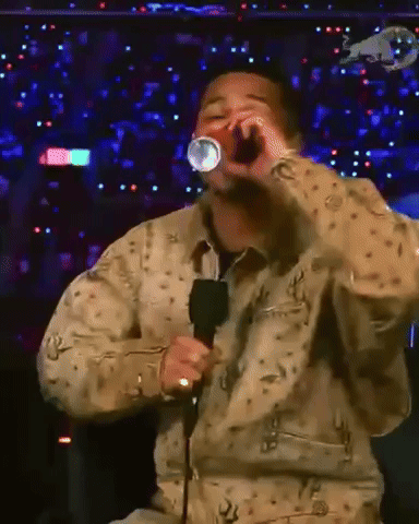 Man Singing Into Microphone With Red Bull Logo GIF